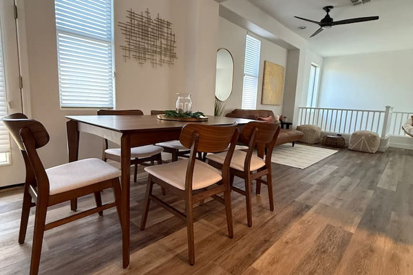 Dining area with table seating, natural light, and an open view toward for the lounge space.