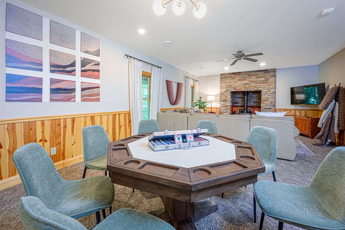Basement living room with Roku TV and game table for hours of fun