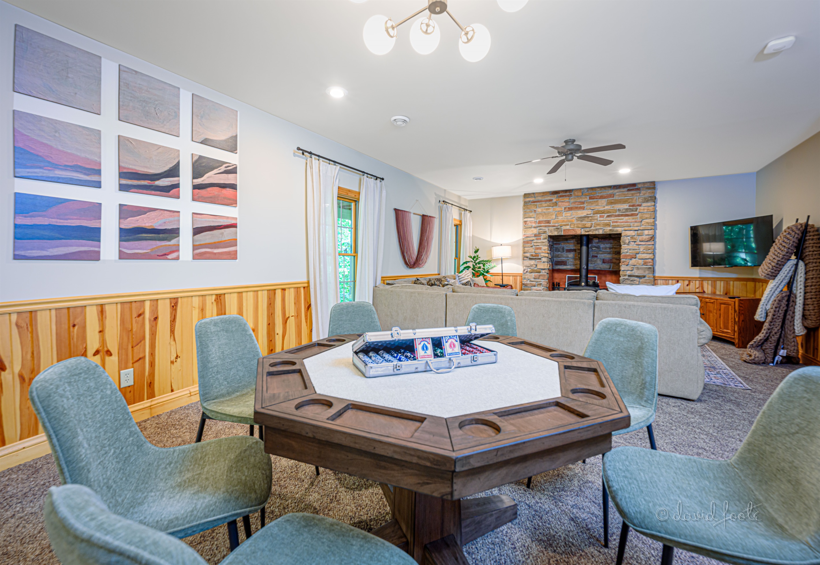 Basement living room with Roku TV and game table for hours of fun
