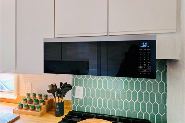 Cook in style—our smart stainless range, tile backsplash, and microwave hood make meals effortless. Stocked spices and generous cookware spark your culinary creativity.