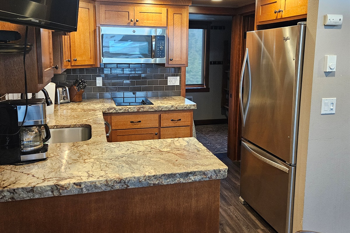 Kitchen area leading to bedroom & bathroom.