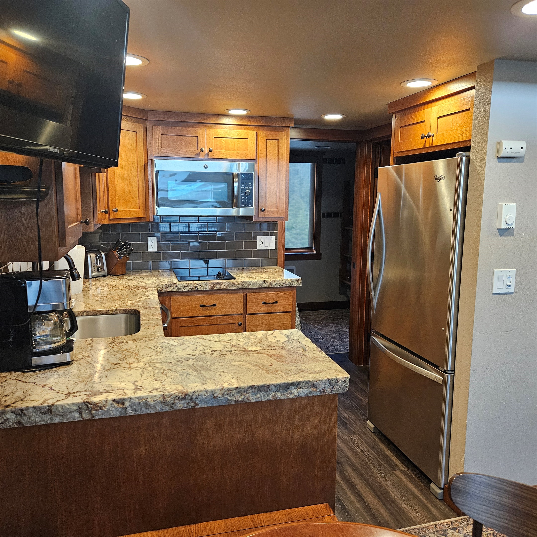 Kitchen area leading to bedroom & bathroom.