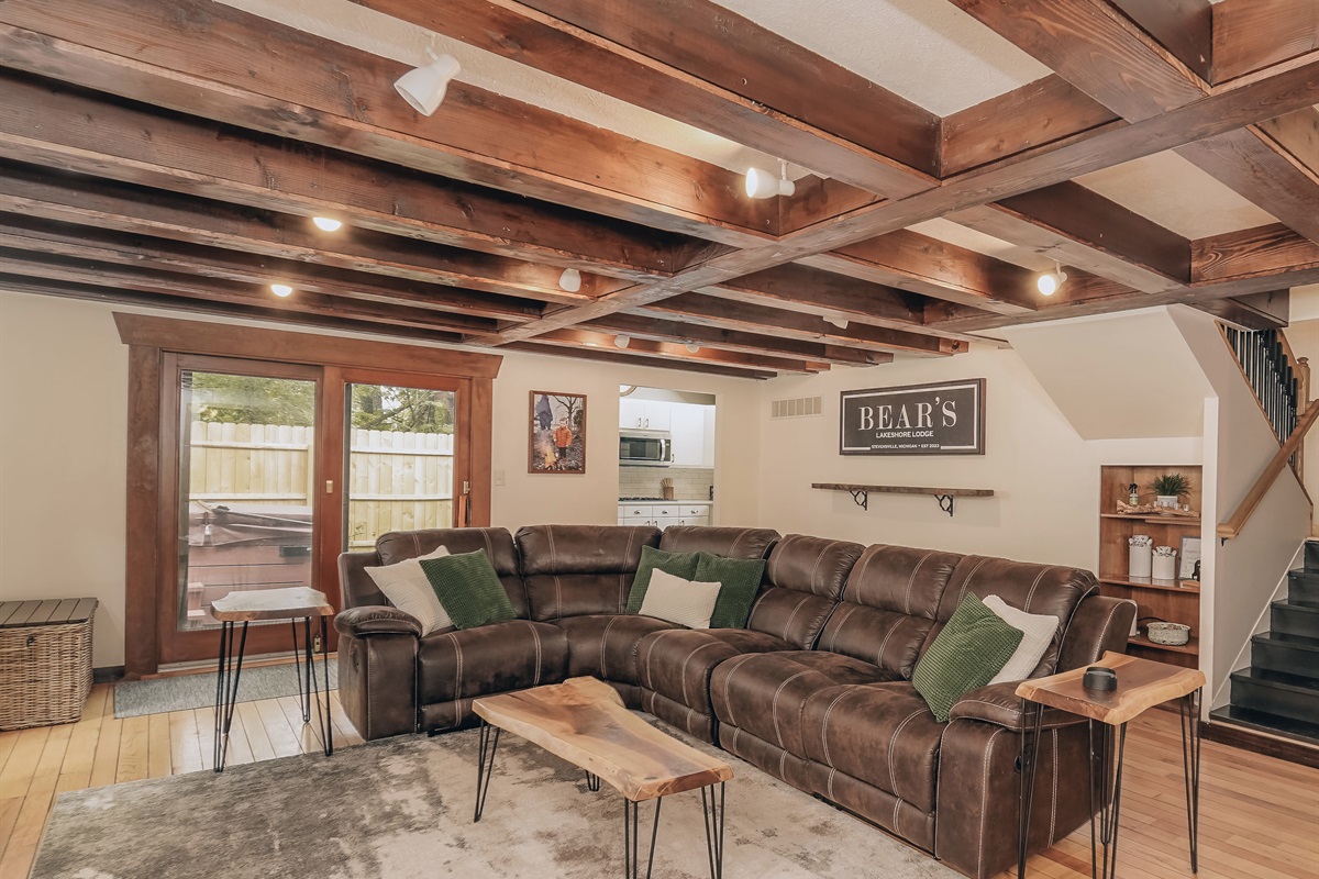 Get cozy! The living room really gives the “lodge feel” to the home. This cozy space is complete with a spacious sectional sofa and a 75” smart TV, making it the perfect spot to kick back and enjoy a movie! 