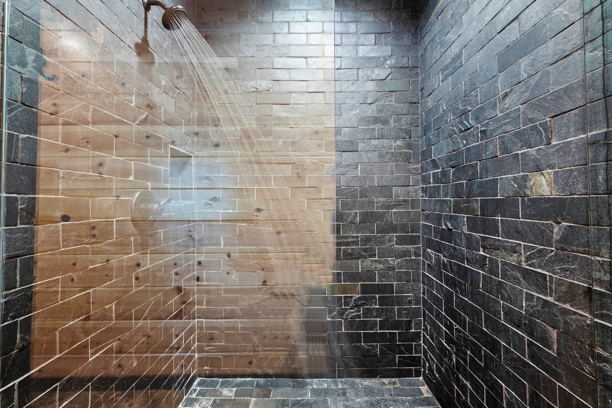 Walk-in tile shower with modern finishes and rainfall showerhead.
