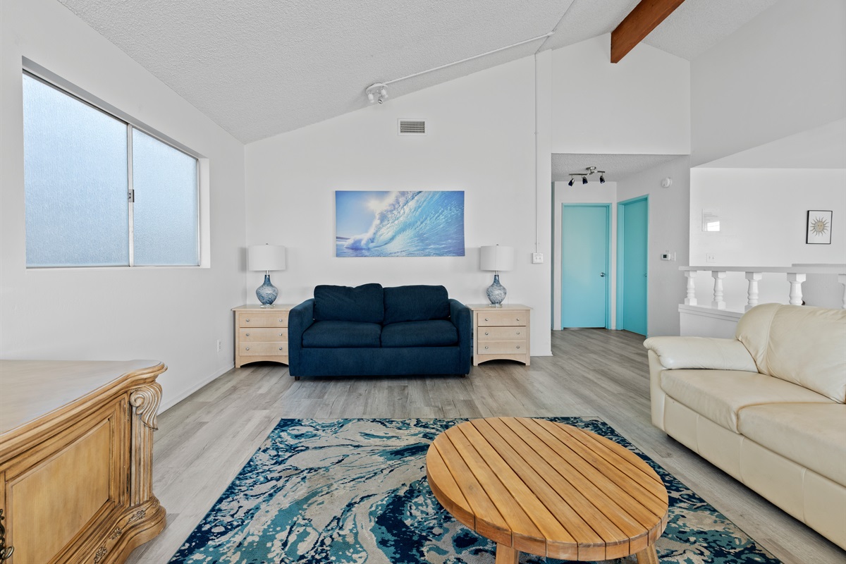 Bright, comfortable living area with seating and smart TV