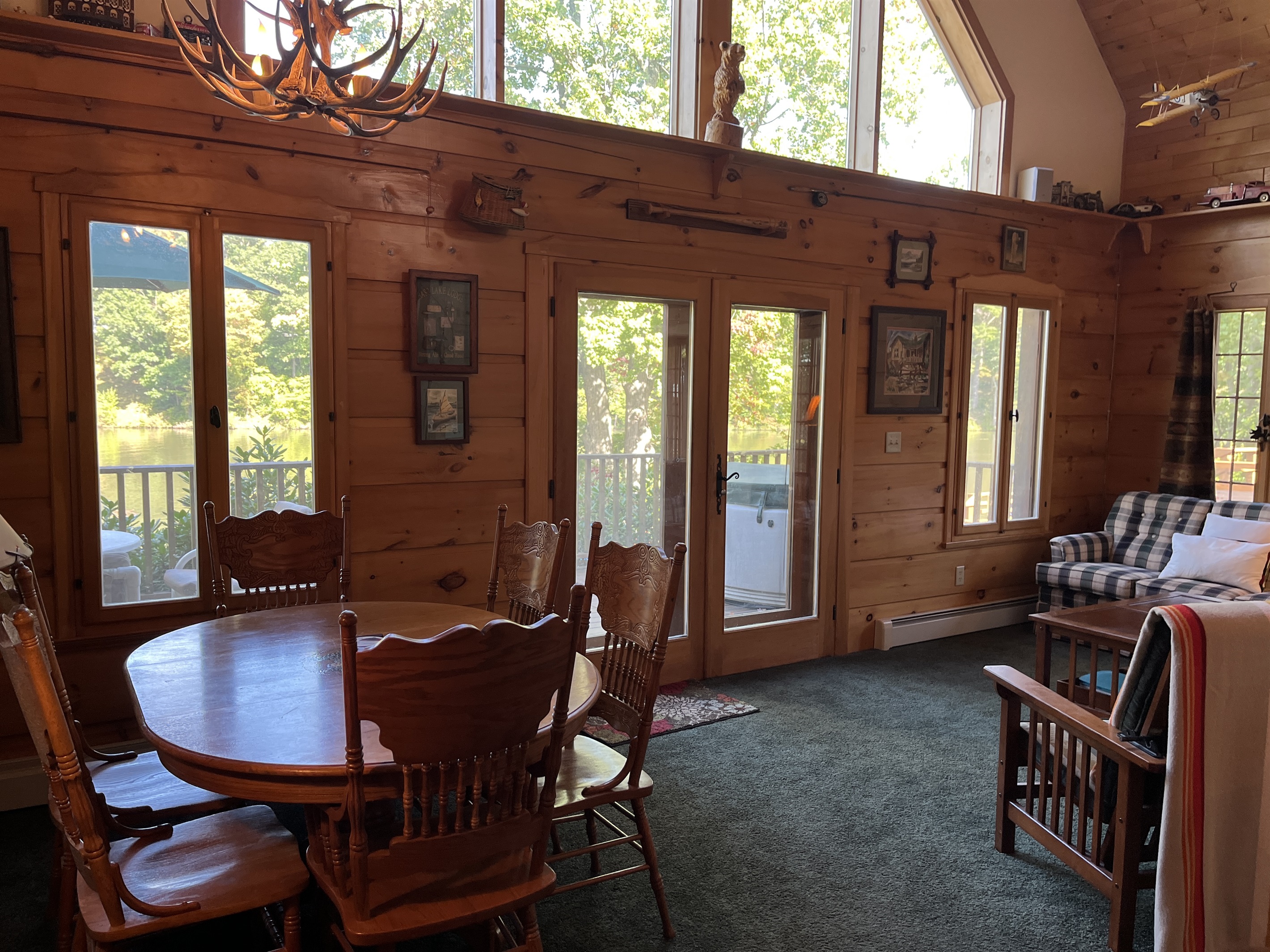 Living/dining area with windows facing the water