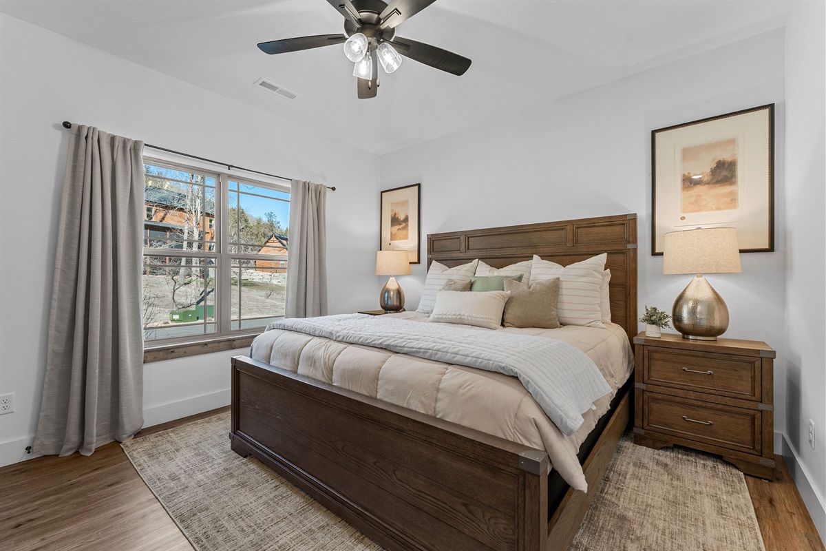 Comfy king bed with attached ensuite bathroom on the main level. A great place to find rest and relaxation after a full day of adventure.