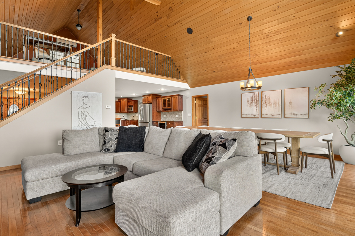 Open-concept living area with loft overlooking kitchen