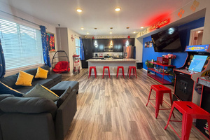 The ultimate hangout spot! Relax on the spacious sectional, play a round on the arcade cabinet, or lounge in the hanging egg chair. Features a fully equipped kitchen with breakfast bar seating, perfect for socializing while cooking.
