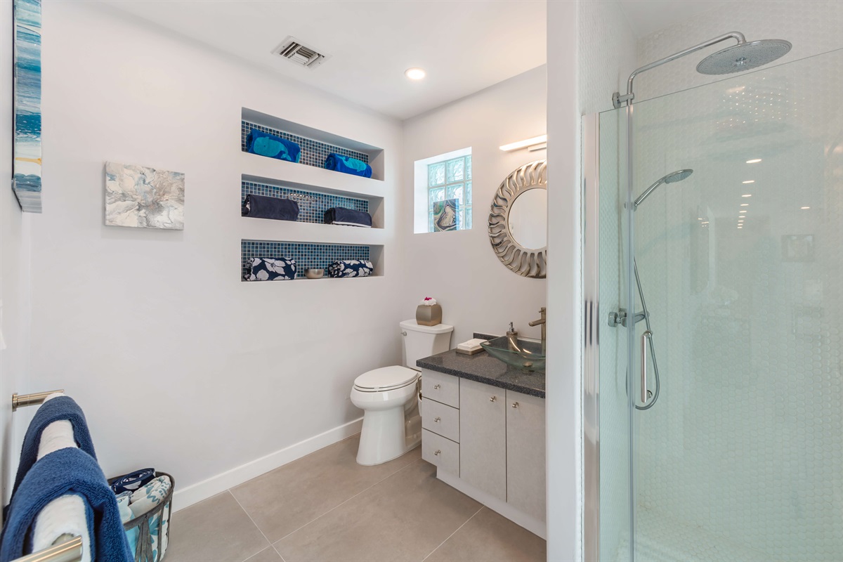 This full bathroom is located off of the pool deck