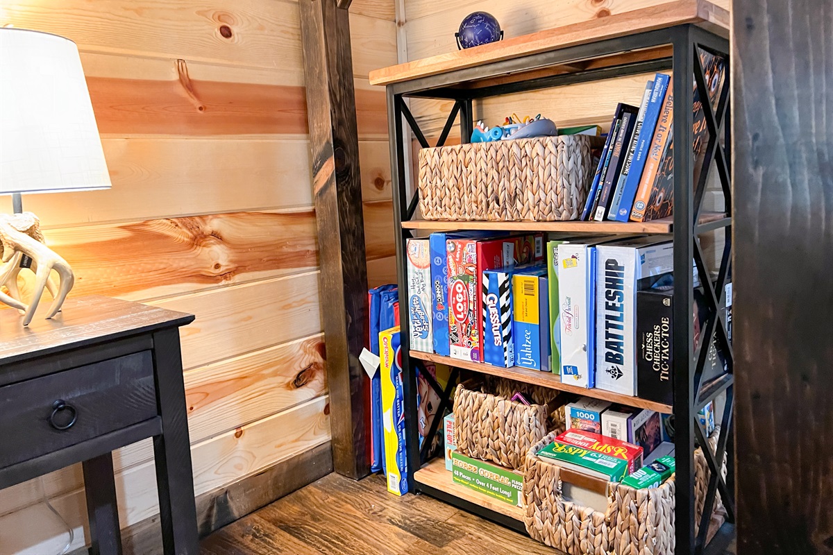 Bookcase of games and toys tucked away under the bunk.