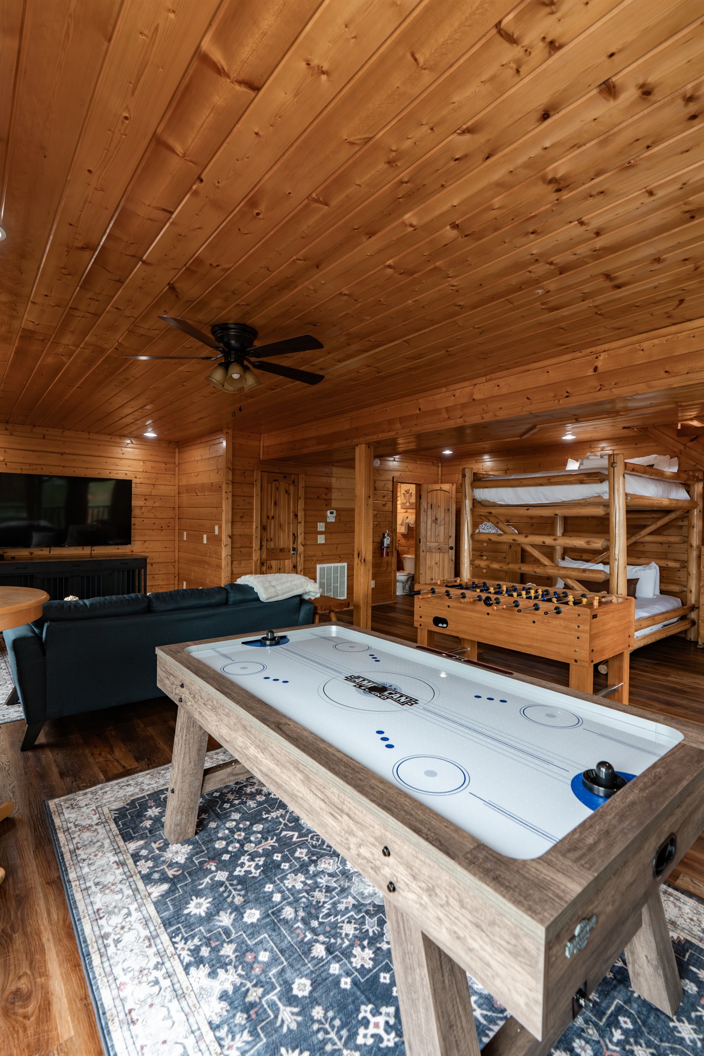 Every game, every angle — air hockey, foosball, Smart TV, and sleeping space for the whole crew, all on the lower level.