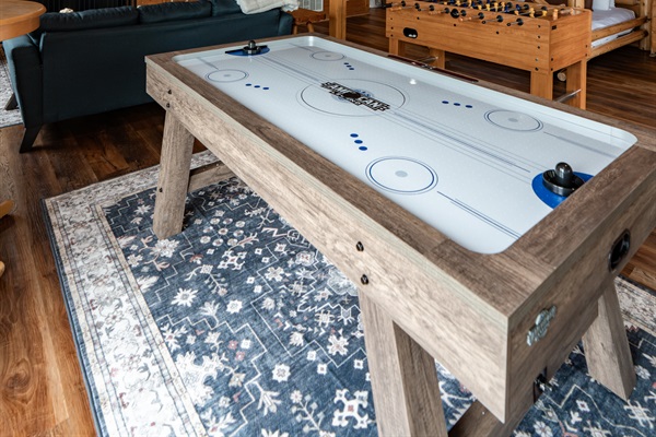 Every game, every angle — air hockey, foosball, Smart TV, and sleeping space for the whole crew, all on the lower level.