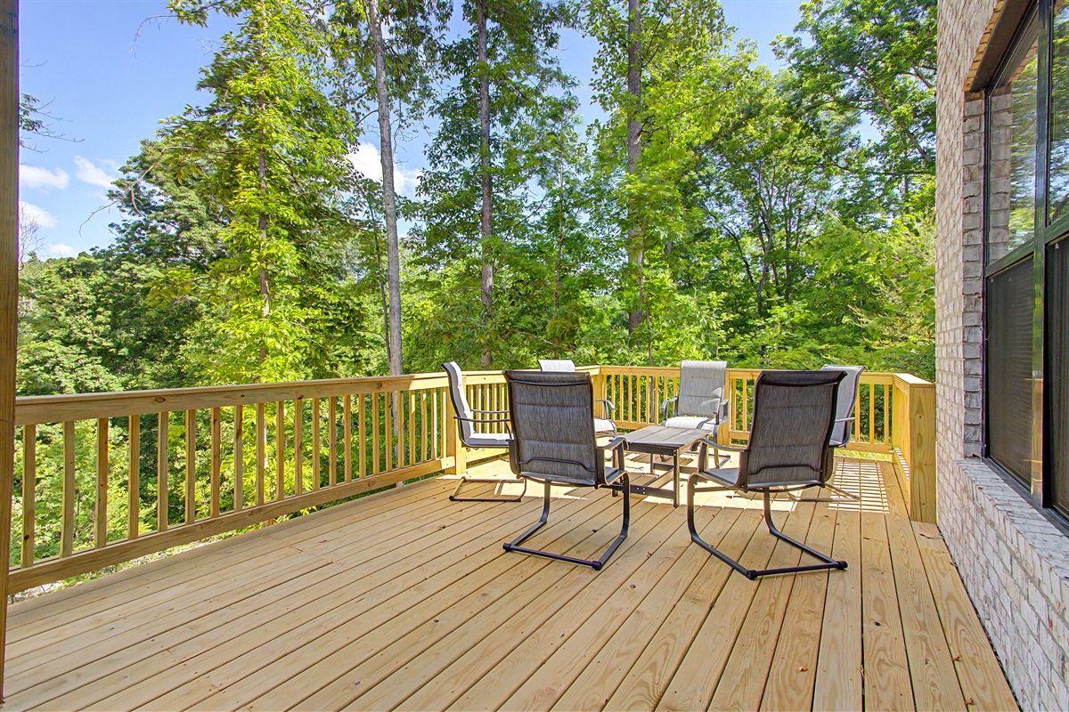 huge lower level deck with seating and hot tub