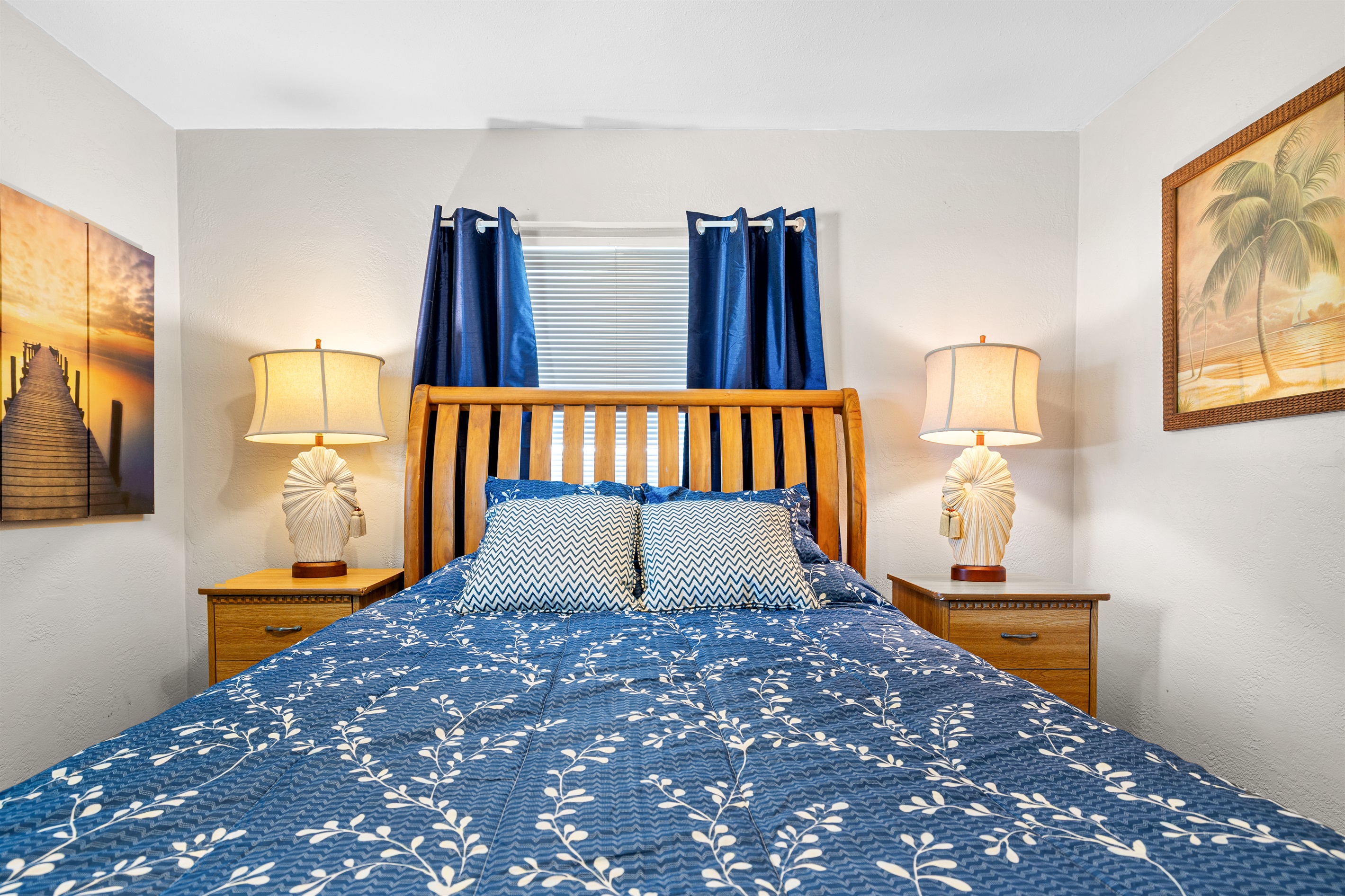 No Wake Queen Bedroom with Roku TV, a bookshelf, 2 nightstands, a dresser and two closet areas.