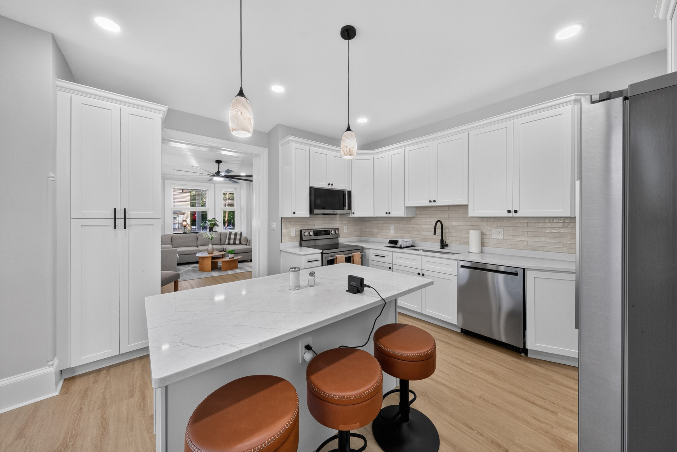 Fully renovated chef's kitchen featuring quartz countertops and center-island seating for 3.