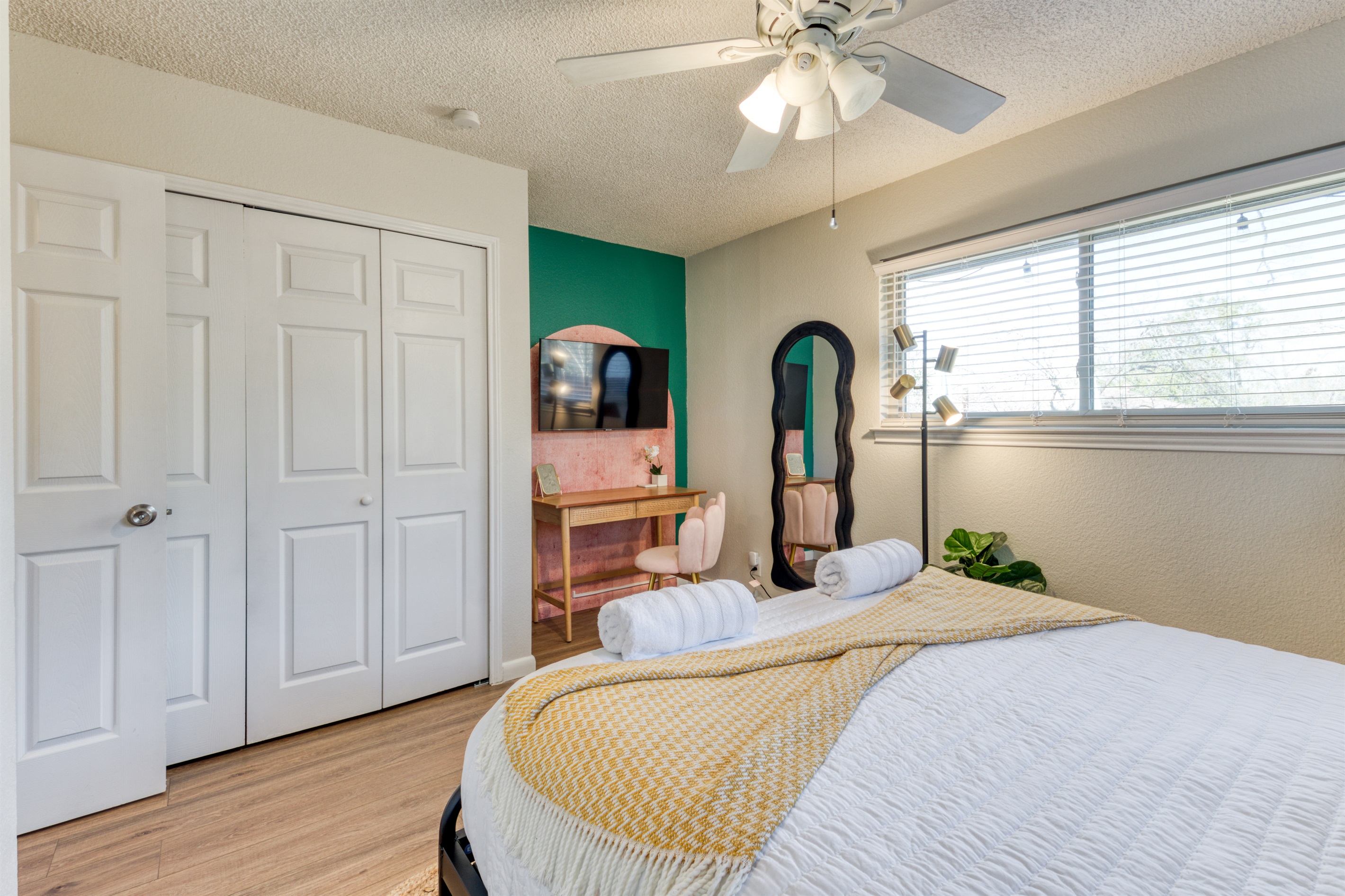 Feminine queen bedroom with vanity and TV