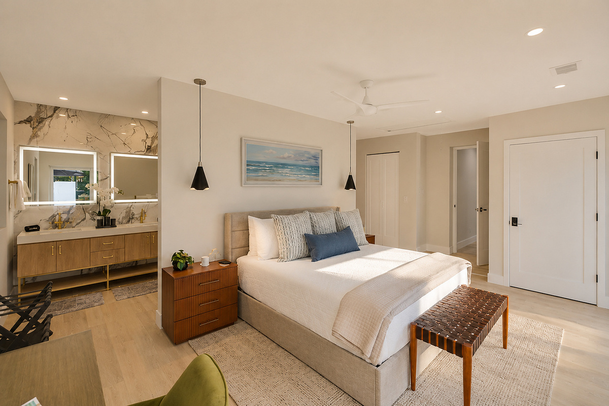 This spacious king suite connects naturally to the vanity and bath area, giving guests comfort, privacy, and room to settle in.