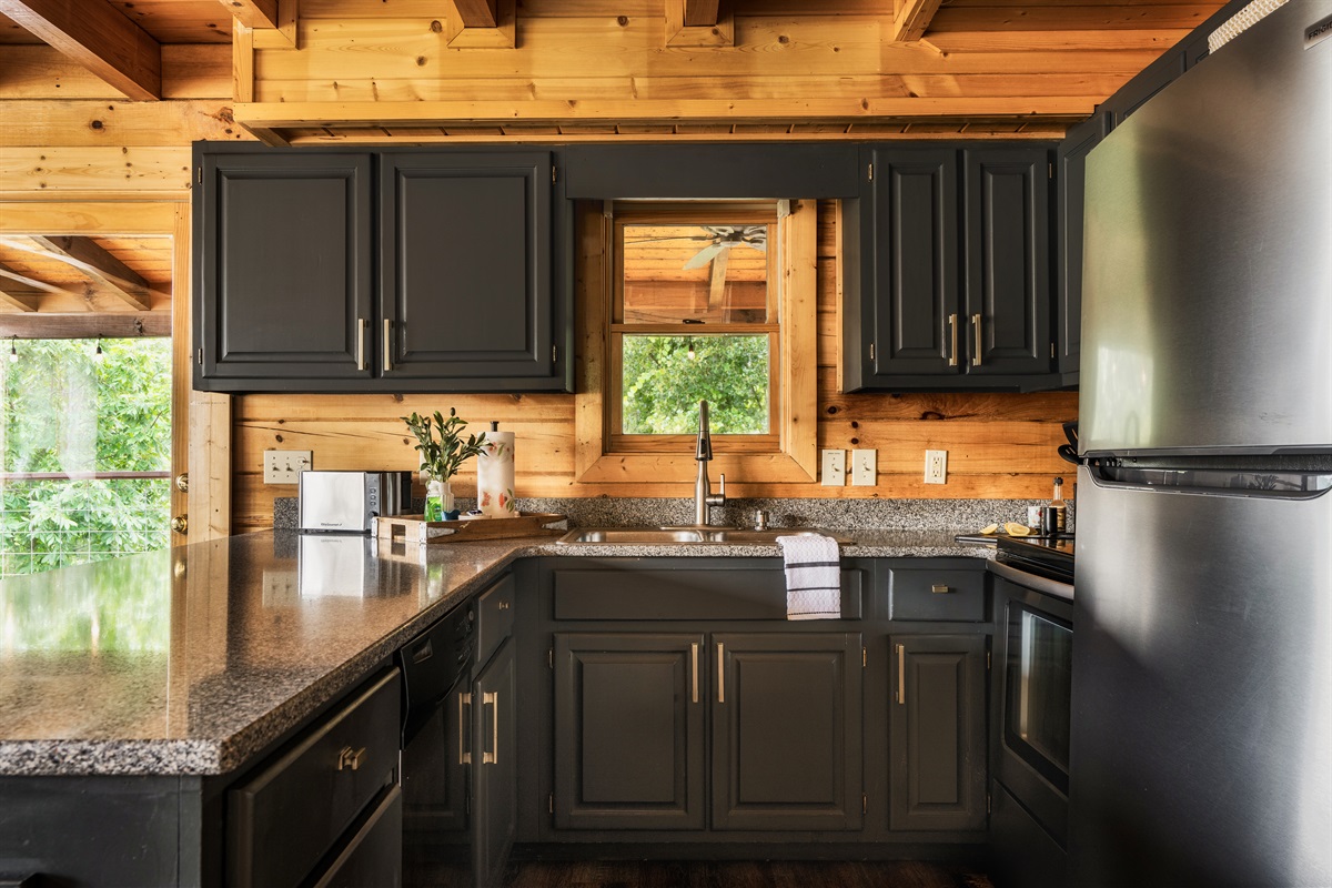 Our well-stocked kitchen has a granite countertop and seating for four