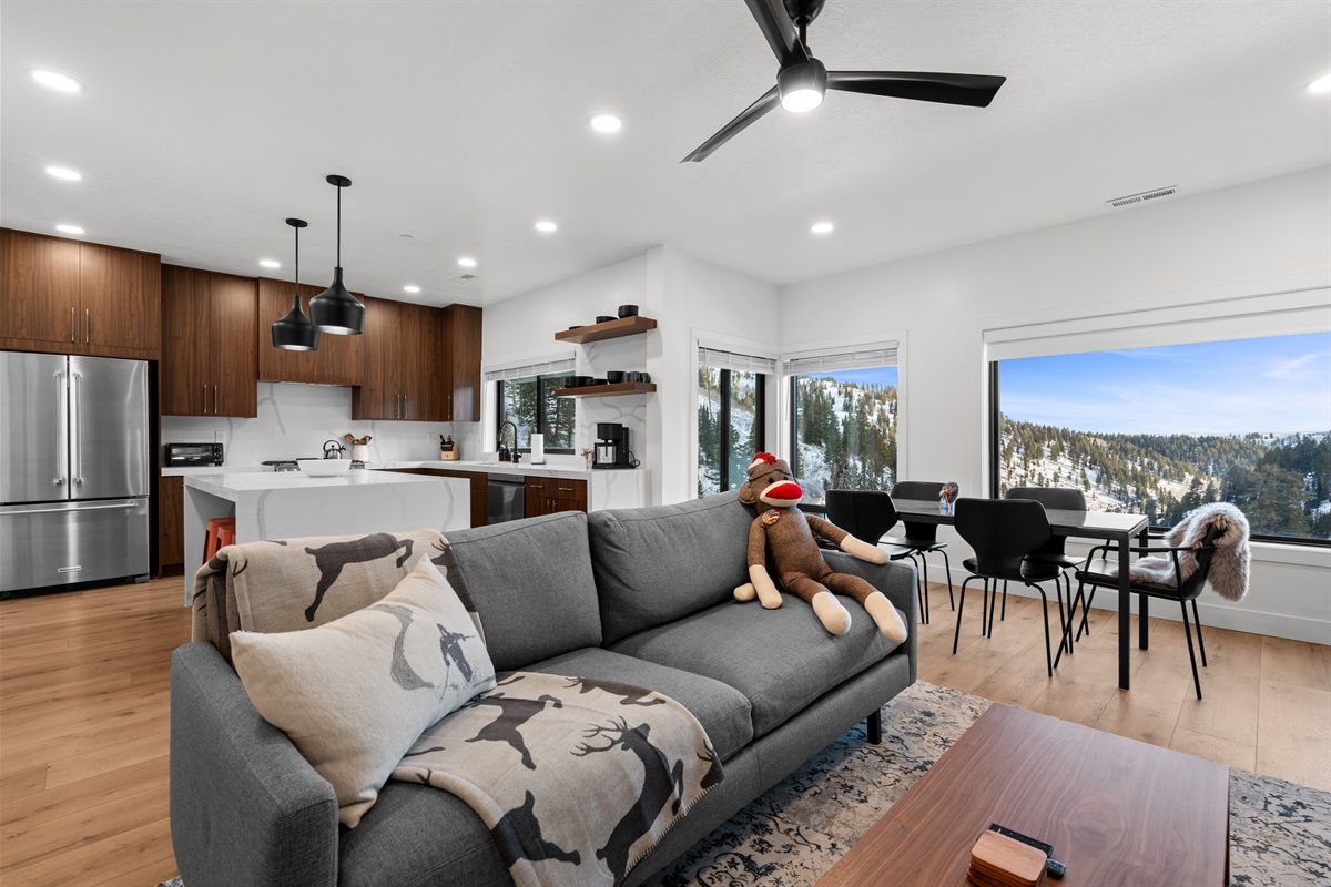 Bright, open living room with mountain views — unwind fireside after epic Powder Mountain ski days.
