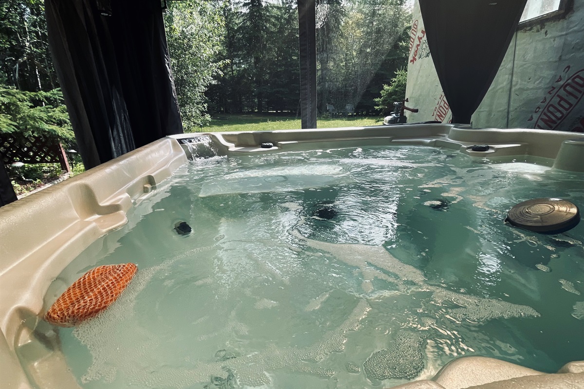 Private hot tub surrounded by trees for relaxing soaks