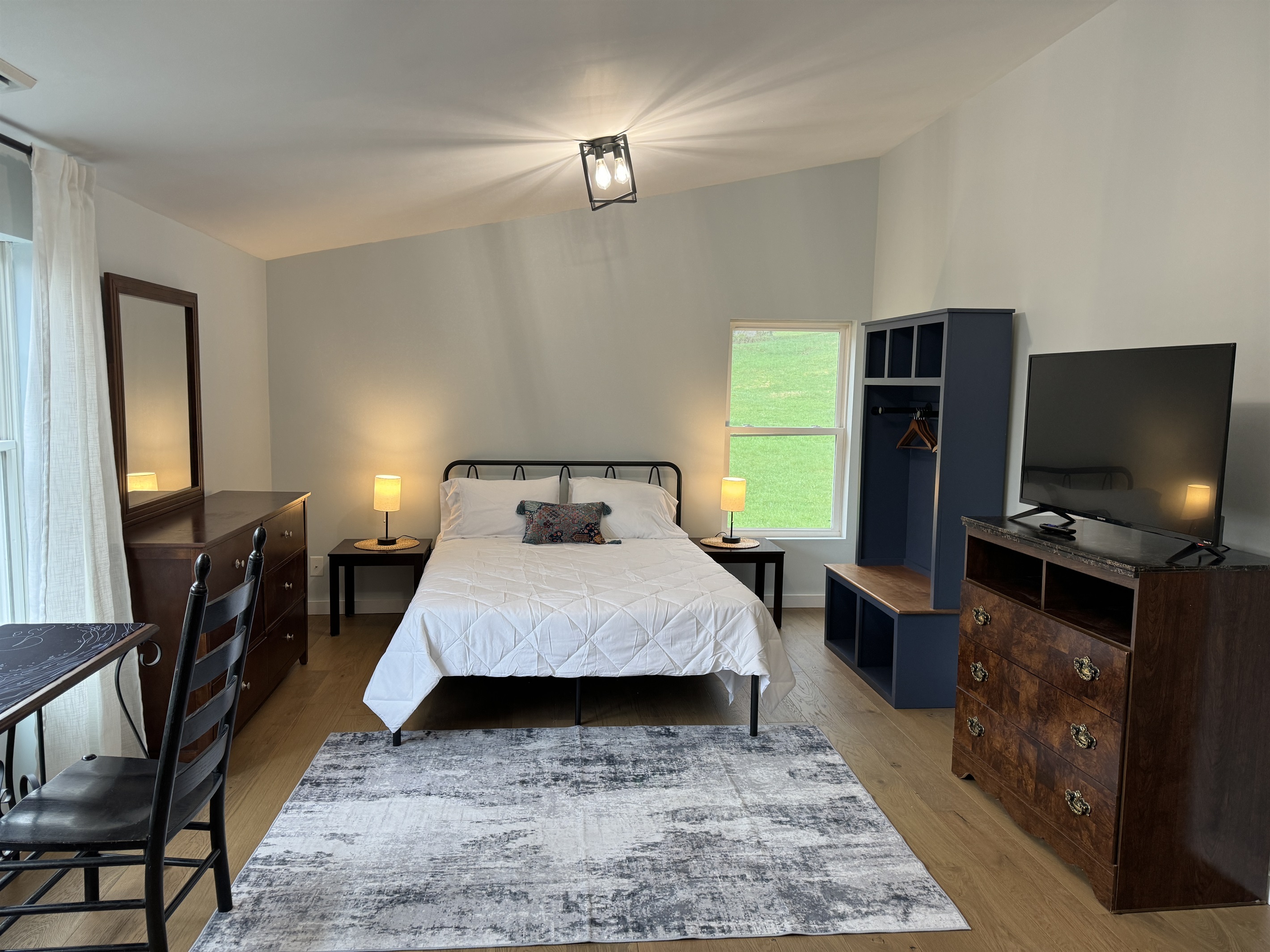 Primary Queen bedroom with desk and lounge area