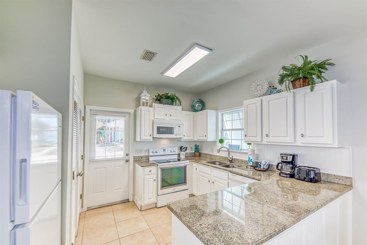 Kitchen: Bright and airy for culinary adventures, complete with modern appliances and charming decor!