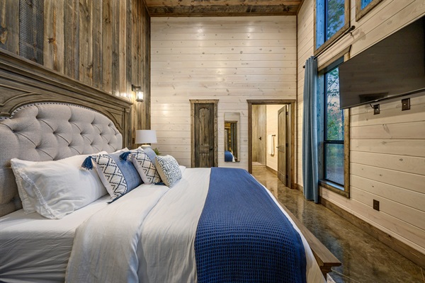 Cozy cabin bedroom with rustic wood walls and serene forest views