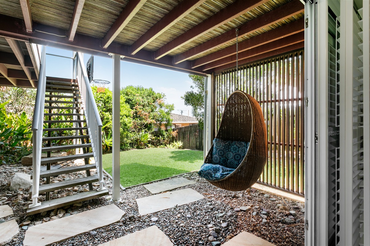 Hide away from the chaos in your vintage egg chair nook.