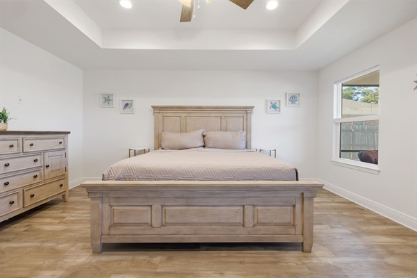This is the master bedroom with a king-size bed.  Look out the window into the backyard and see your kids and pets play.  The master bedroom includes a walk-in shower and a 50-inch Roku TV.