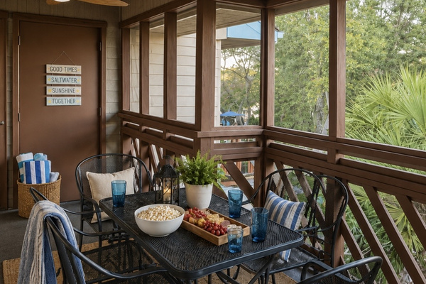 Enjoy meals or morning coffee in the enclosed porch dining area, surrounded by windows and natural light, and overlooking the outdoor pool — a bright, cheerful spot to start your day. ⭐