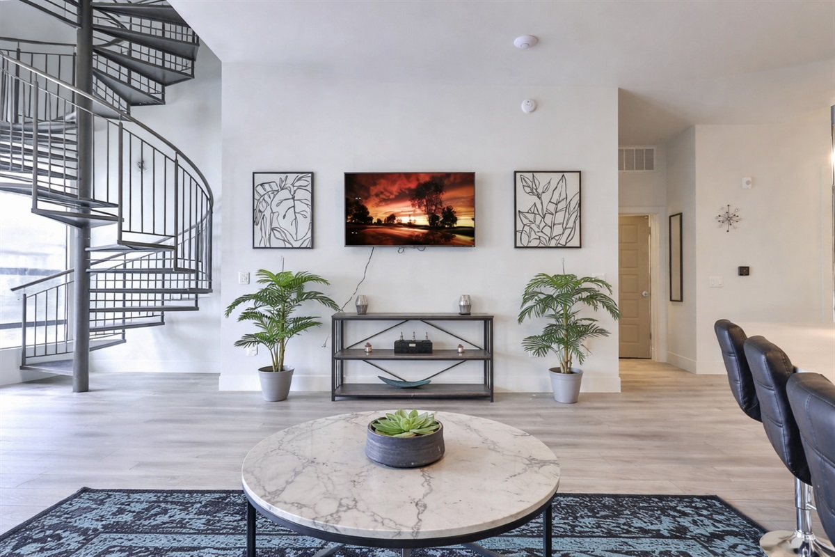 Inviting living room with plush seating, stylish design, and a warm, relaxing ambiance. Includes a smart TV and open layout, perfect for lounging, entertaining, or unwinding during your stay.