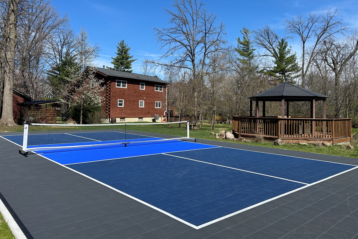 Private onsite regulation size pickleball court with Sport Court surface.