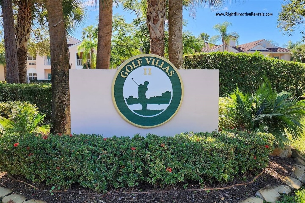 Golf Villas community entrance sign surrounded by lush tropical landscaping.