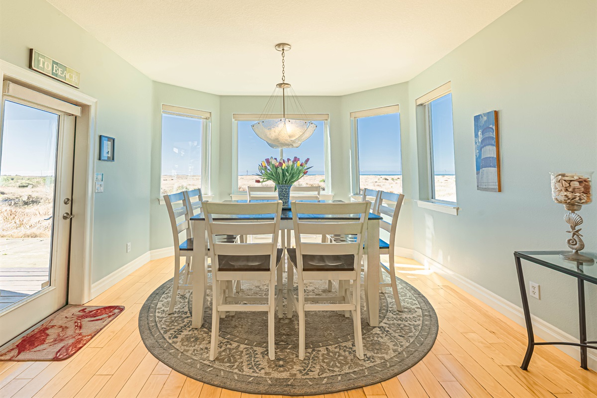 Dining room with beautiful ocean views and seating for 8..  There are 4 additional seats at the kitchen bar.