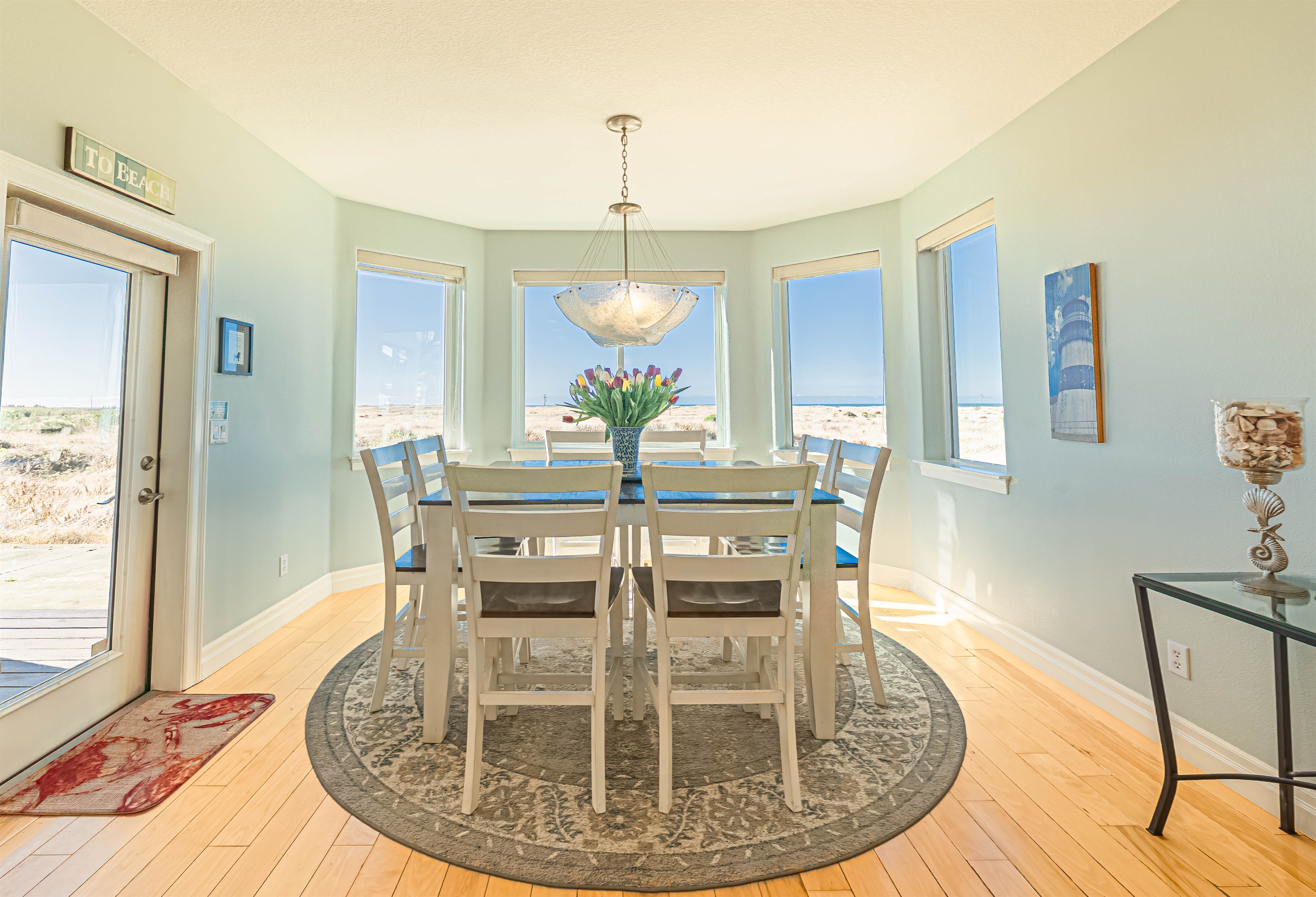 Dining room with beautiful ocean views and seating for 8..  There are 4 additional seats at the kitchen bar.