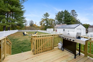 Deck with grilling kitchen and fenced backyard