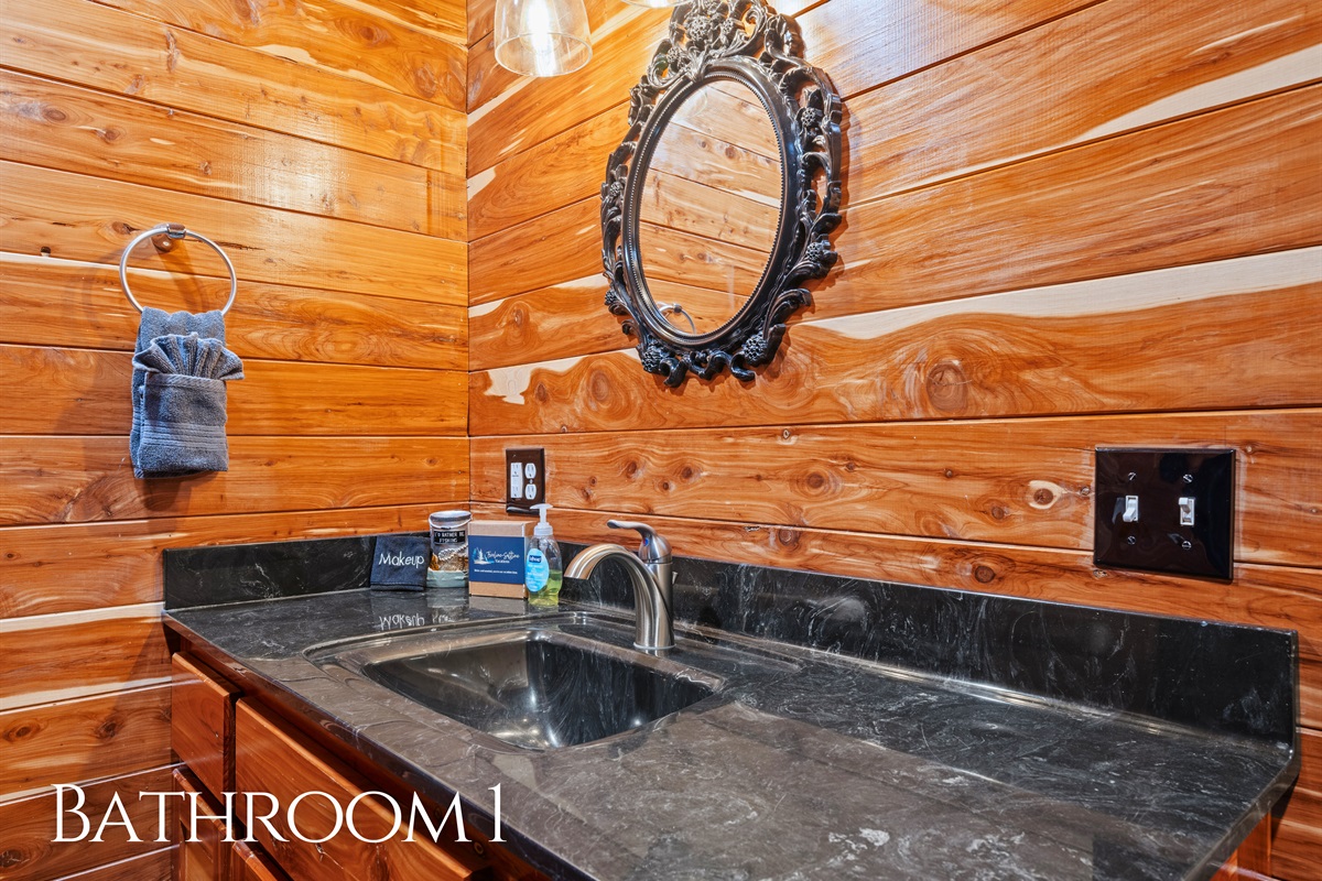 Finished with rustic touches, this bathroom includes a wide vanity and ample space for getting ready with ease.