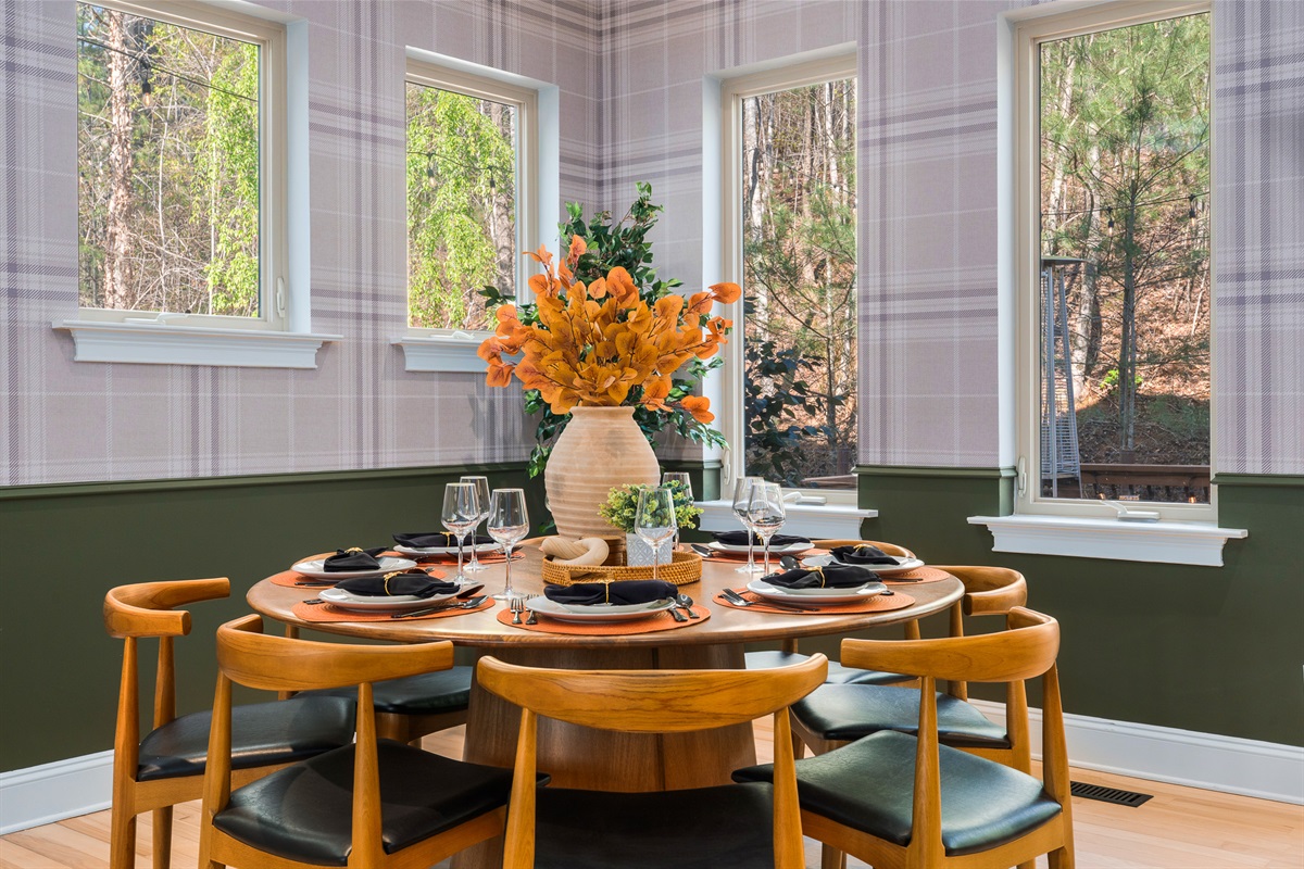 Dining space surrounded by windows - natural light and wooded views during every meal
