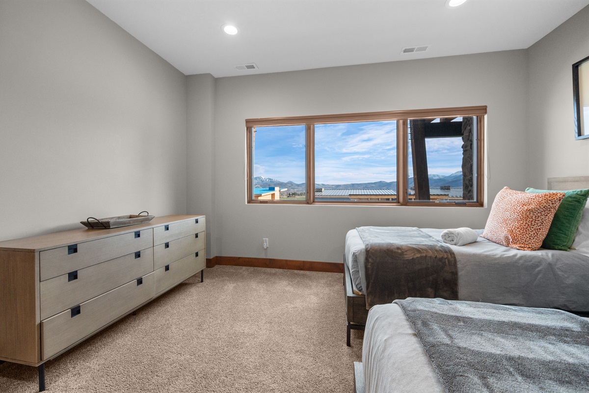 Spacious bedroom with dual beds and cozy layout and stunning view.