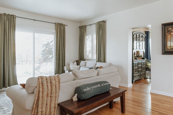 The living room is another great gathering spot. Two sofas, a large flat screen TV, views of old growth lilacs, and a grand cottonwood tree. This space is open to the dining room, which makes for a great entertainment space.   