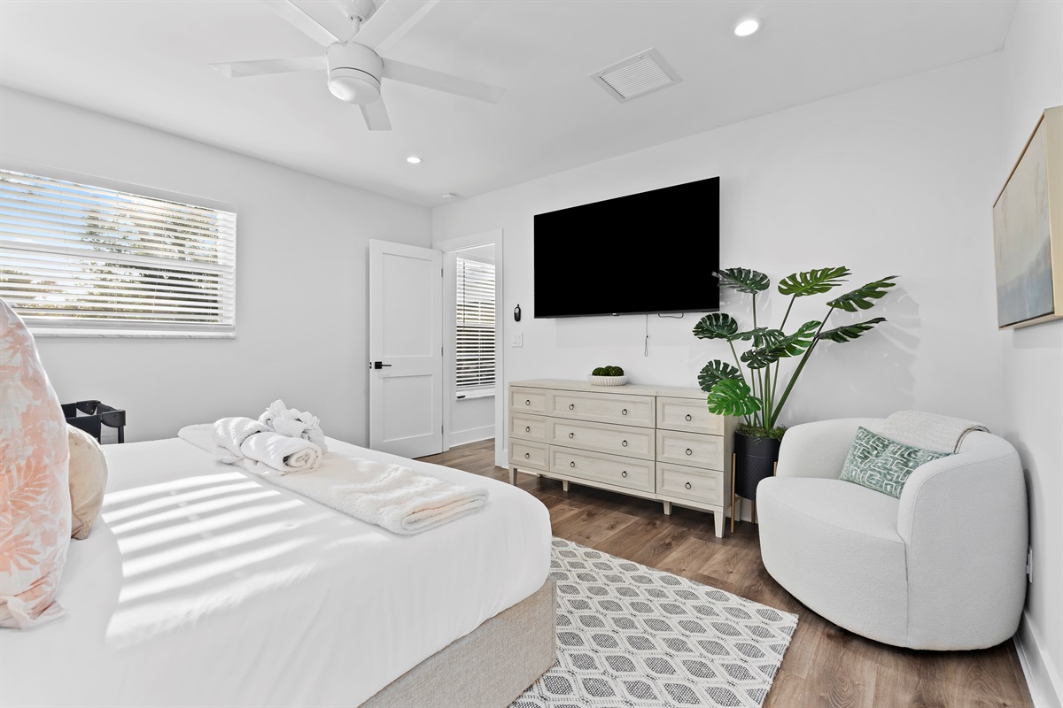 Wake up refreshed in this peaceful and airy bedroom featuring cozy furnishings, stylish touches, and a relaxing atmosphere made for restful nights.