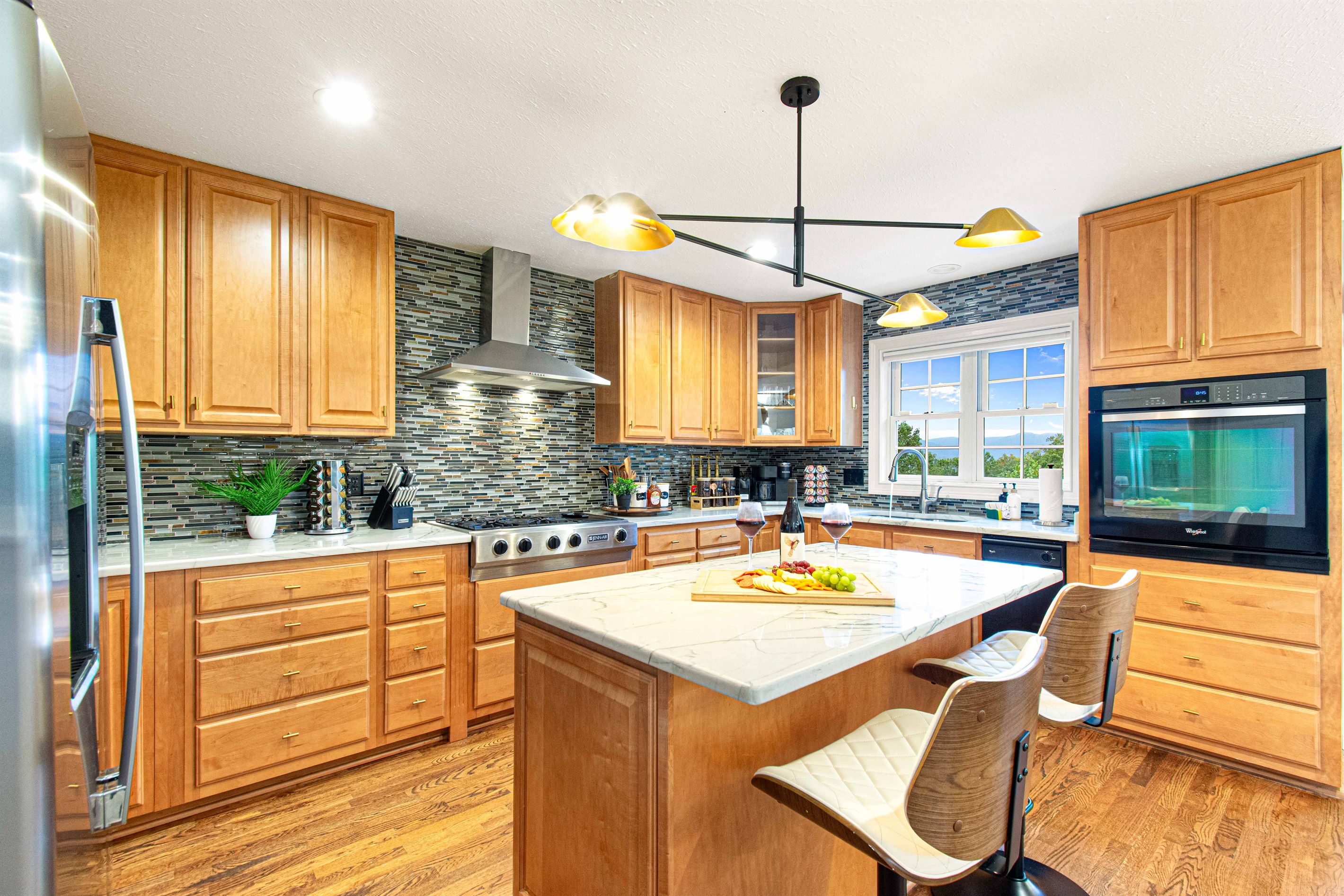 Prepare meals in this modern kitchen featuring sleek appliances, a spacious island, and plenty of natural light. Perfect for gatherings and gourmet cooking!