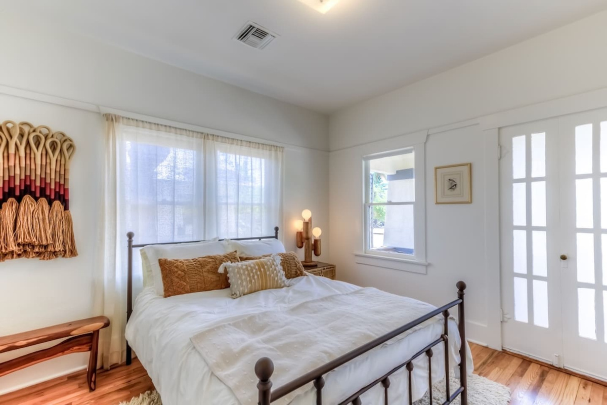 Bedroom 1 with queen bed and blackout shades
