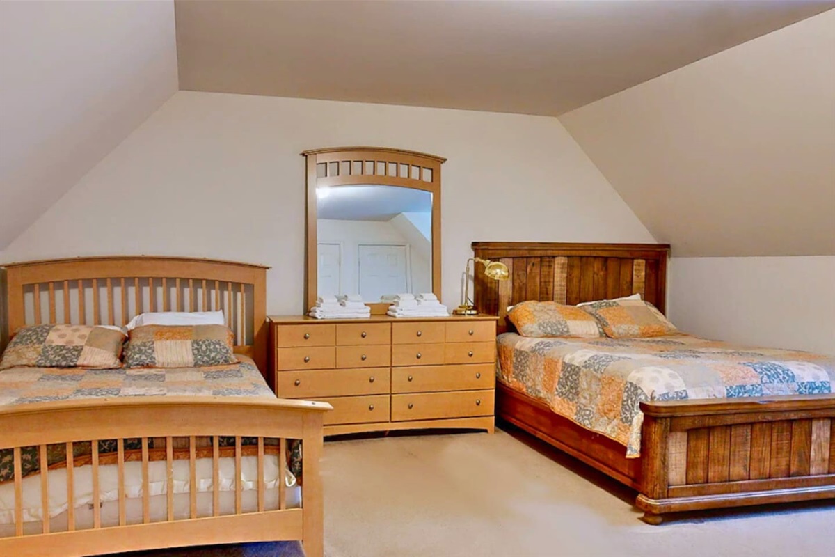 Second bedroom on second floor with 2 Queen Sized beds.