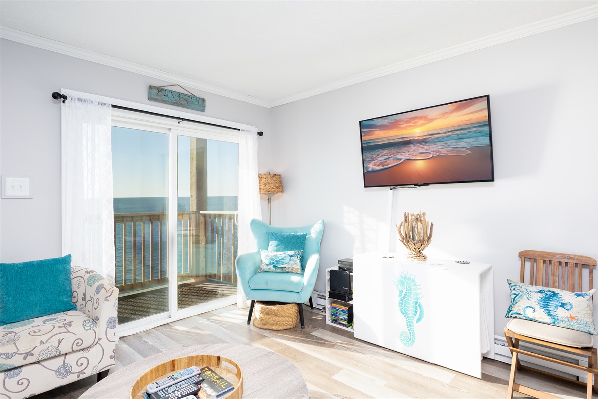Living area with ocean vistas and TV for entertainment