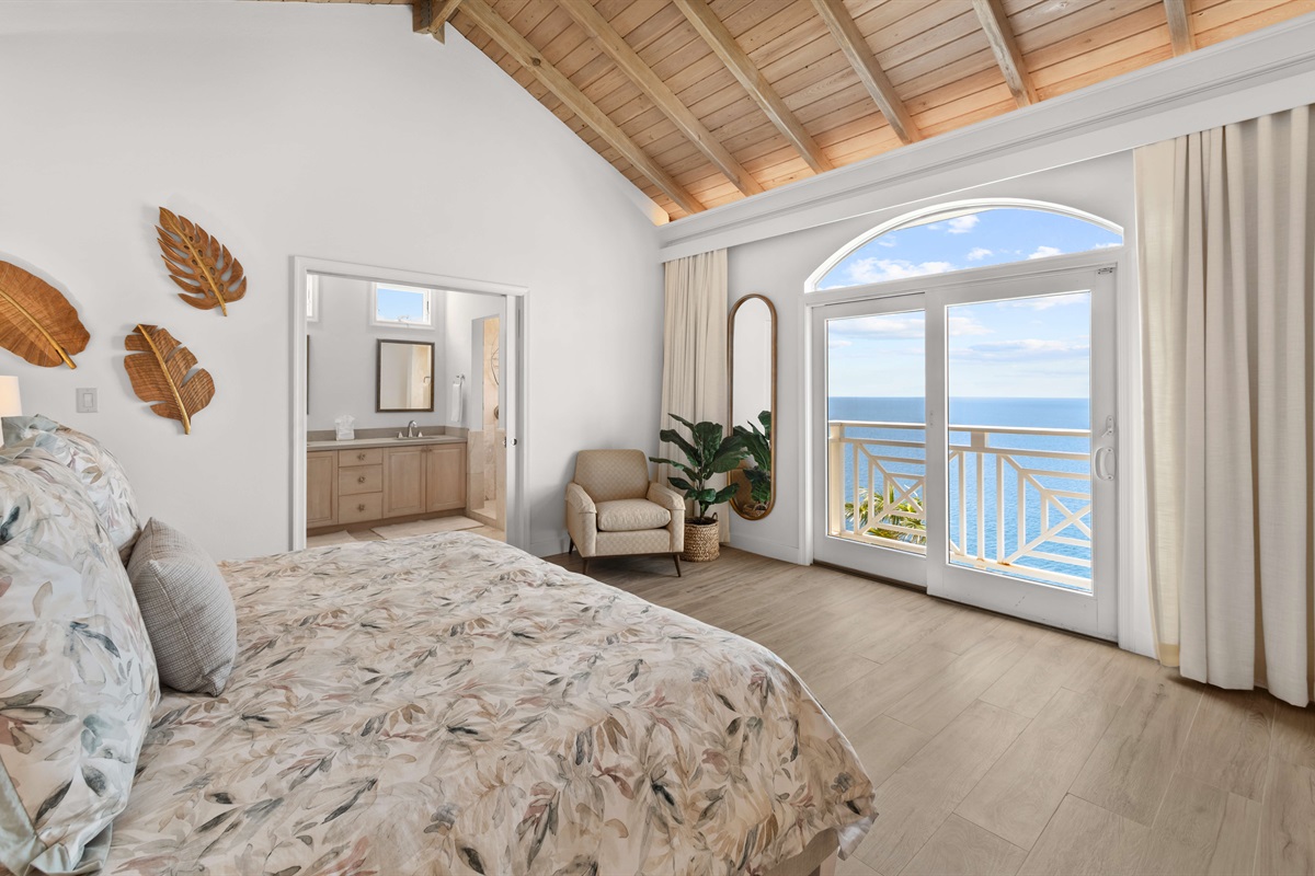 Primary suite with AC, king bed, en-suite bath, large windows, and ocean views. Ideal for privacy and relaxation.