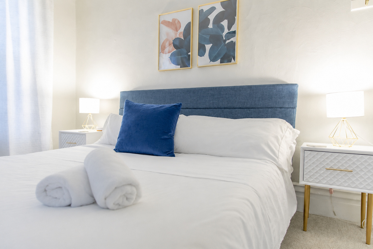 Discover the King Bedroom, a spacious room on the second floor with king bed flanked by nightstands with lamps.