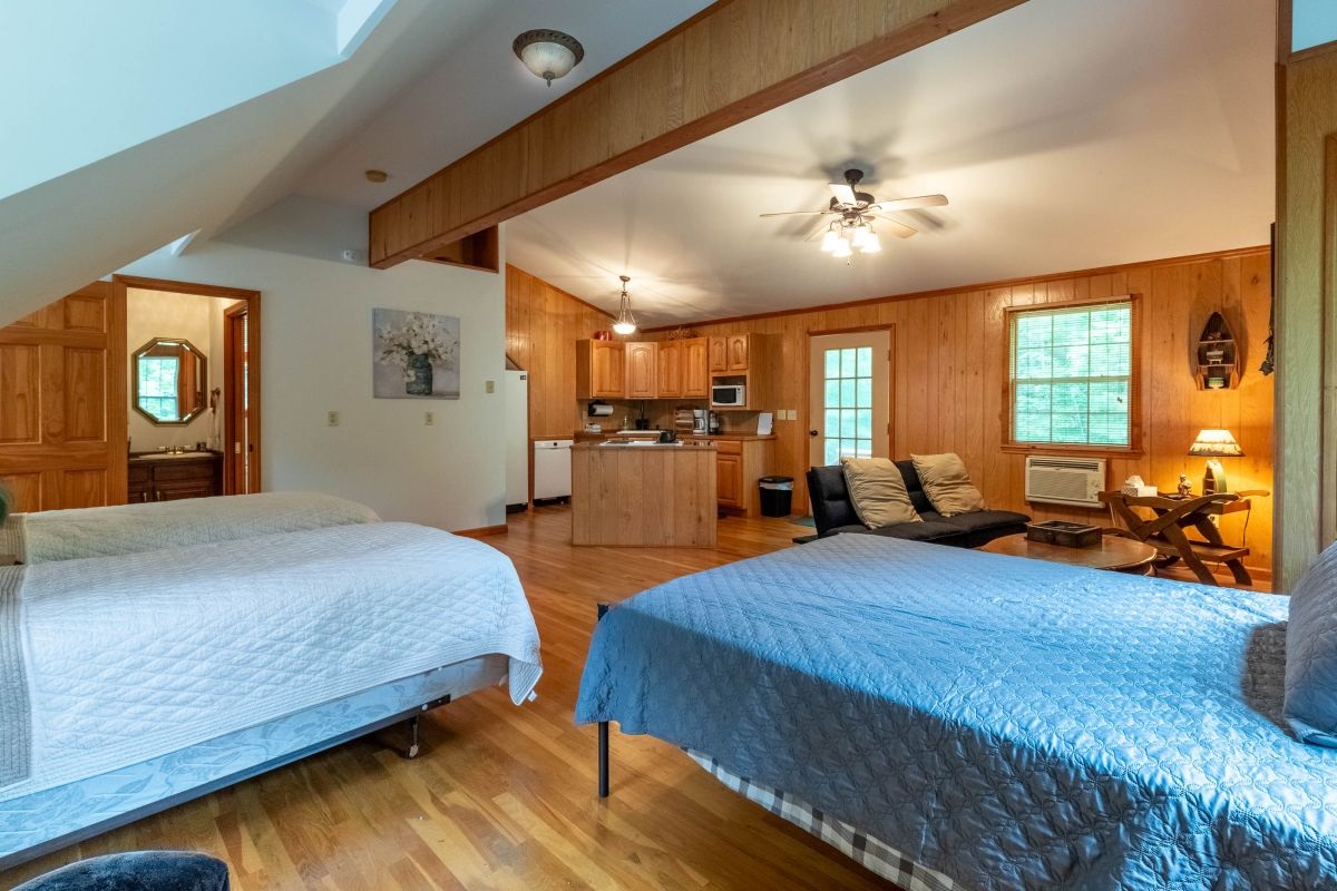 Spacious Bedroom Retreat: Enjoy tranquil vibes, vaulted ceilings, and inviting wooden accents!

