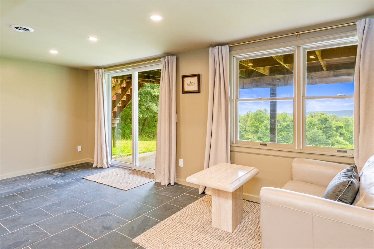 Wake up to stunning views from this walkout lower level bedroom suite with private sitting area and patio access.
